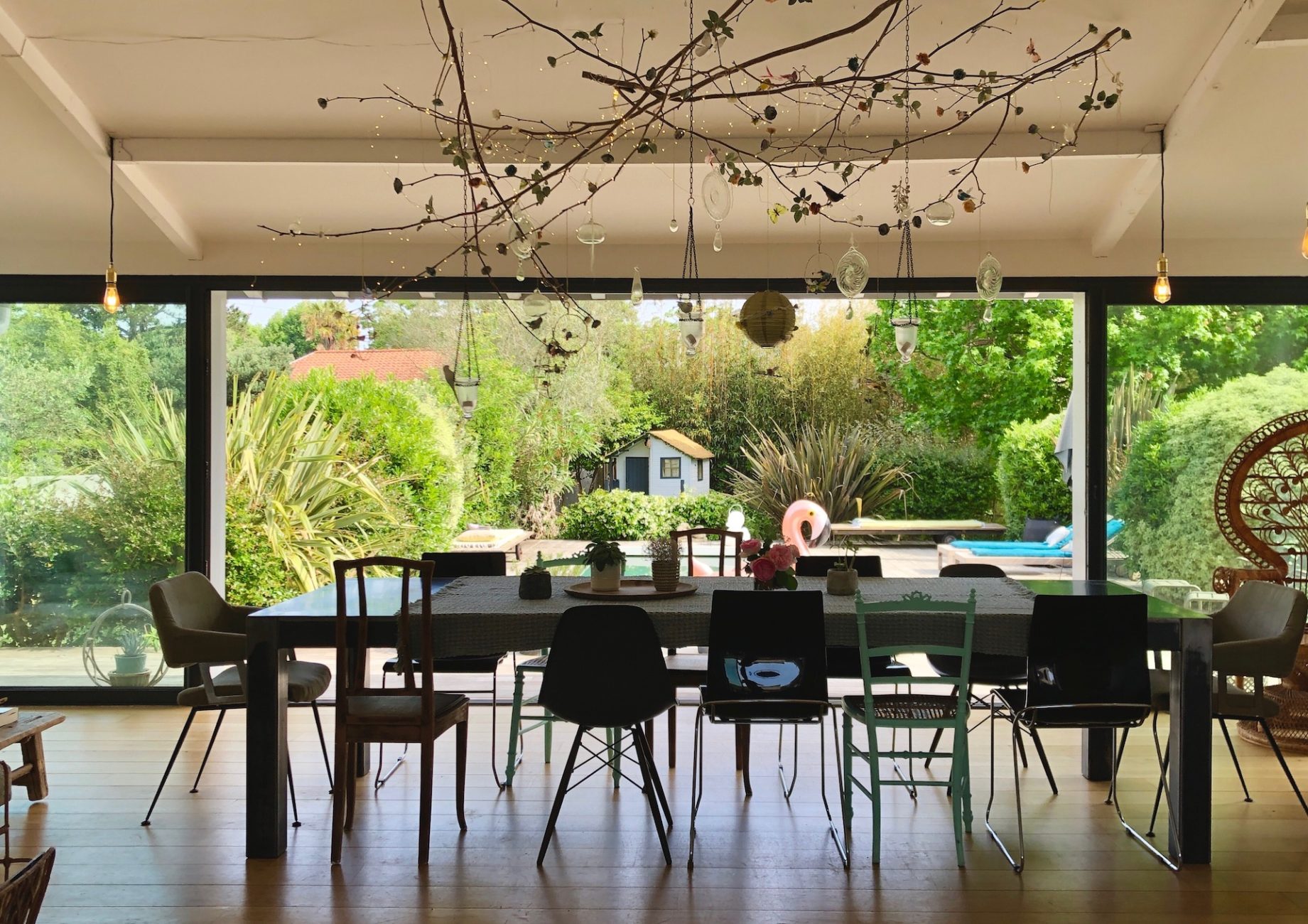 Maison Lekua dining room with view of garden house on stilts for the children, home away from home, Anglet, Basque Country, France, SimpleLuxe